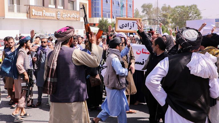 Taliban forces try to stop the protesters, as they shout slogans during an anti-Pakistan protest, near the Pakistan embassy in Kabul, Afghanistan