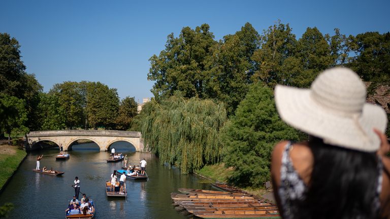 People make the most of the hot weather as they enjoy punt tours along the River Cam in Cambridge
