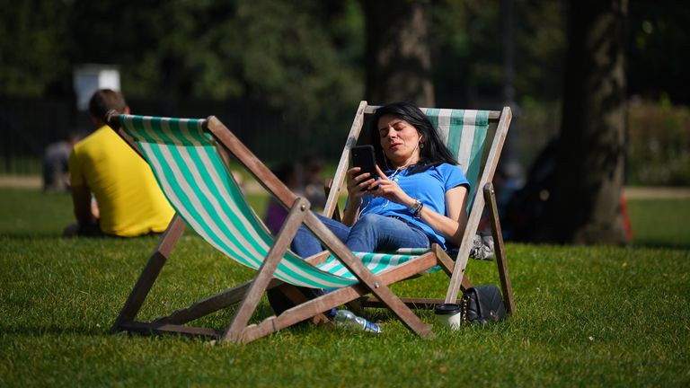 A woman enjoys the sun in St James&#39;s Park on Sunday