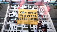 Animal Rebellion activists hang a banner from the side of the Home Office building, in London, Britain October 26, 2021. REUTERS/Henry Nicholls  