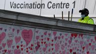 National Covid Memorial Wall, a dedication of thousands of hand painted hearts and messages commemorating victims of the COVID-19 pandemic, is seen in London  A street cleaner wearing a protective face mask works in the grounds of St Thomas&#39; Hospital, beside the National Covid Memorial Wall, a dedication of thousands of hand painted hearts and messages commemorating victims of the COVID-19 pandemic, in London, Britain, October 20, 2021. REUTERS/Toby Melville
