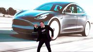 Elon Musk dances onstage during a delivery event for Tesla Model 3 cars in Shanghai