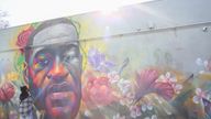 A woman pays her respect at a mural of George Floyd after the verdict in the trial of former Minneapolis police officer Derek Chauvin, found guilty of the death of Floyd, in Denver, Colorado