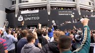 Jubilant Newcastle United fans celebrate the club&#39;s Saudi takeover outside the stadium.