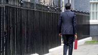 Chancellor of the Exchequer Rishi Sunak carries his ministerial &#39;Red Box&#39; as he leaves 11 Downing Street before delivering his budget