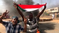 A protester waves a flag during what the information ministry calls a military coup in Khartoum, Sudan, October 25, 2021. REUTERS/Mohamed Nureldin Abdallah  