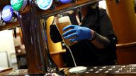 A worker serves a beer at The Holland Tringham Wetherspoons pub