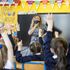 P3 teacher Jessica Cargill with her class at Springfield Primary School in Belfast. Today marks the first day back for Pre-school, nursery and primary school pupils in P1-P3 have retruned to classrooms across Northern Ireland. Picture date: Monday March 8, 2021.