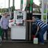 A man filled up a canister at a busy petrol station in London, Monday, Oct. 4, 2021. British military personnel have begun delivering fuel to gas stations after a shortage of truck drivers disrupted supplies for more than a week, leading to long lines at the pumps as anxious drivers scrambled to fill their tanks. (AP Photo/Frank Augstein)