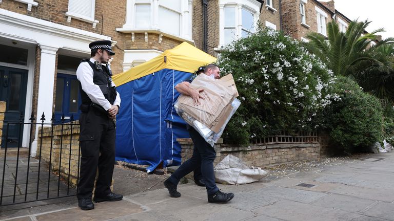 Police remove items from the property in north London