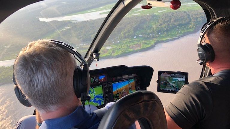 Mark Austin is shown areas of deforestation by police helicopter pilot Raphael Montenegro