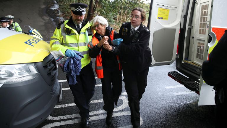 Police officers detain an Insulate Britain activist blocking a motorway junction near Heathrow Airport, in London, Britain, October 1, 2021. REUTERS/Peter Cziborra

