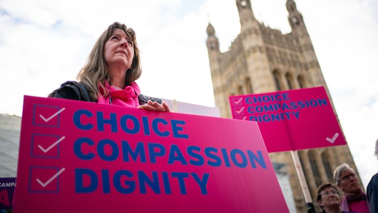 Demonstrators, including Humanists UK&#39;s members and supporters, during a protest outside the Houses of Parliament in London to call for reform as peers debate the new assisted dying legislation. Picture date: Friday October 22, 2021.
