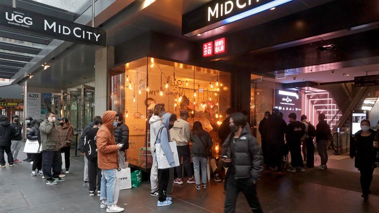 Customers line up to enter a store in the central business district after more than 100 days of lockdown to help contain the COVID-19 outbreak in Sydney, Monday, Oct. 11, 2021. (AP Photo/Rick Rycroft)..