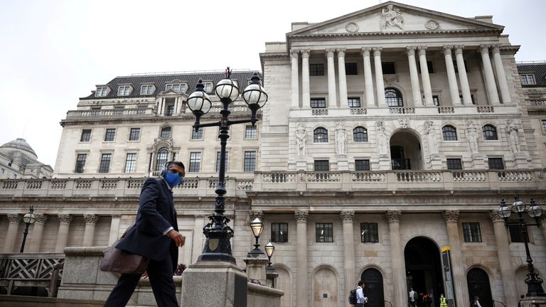  person walks past the Bank of England in the City