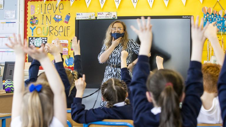 P3 teacher Jessica Cargill with her class at Springfield Primary School in Belfast. Today marks the first day back for Pre-school, nursery and primary school pupils in P1-P3 have retruned to classrooms across Northern Ireland. Picture date: Monday March 8, 2021.
