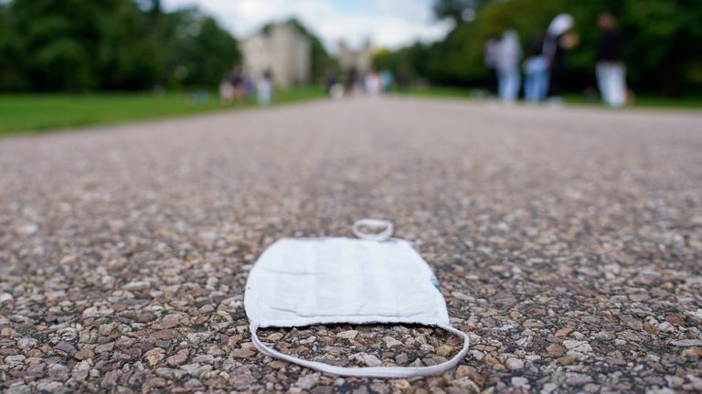 A face mask lies on the ground on the Long Walk, in Windsor, near London,  Tuesday, Aug. 10, 2021. Longtime Jeffrey Epstein accuser Virginia Giuffre sued Prince Andrew on Monday, saying he sexually assaulted her when she was 17. Lawyers for Giuffre filed the lawsuit in Manhattan federal court. 