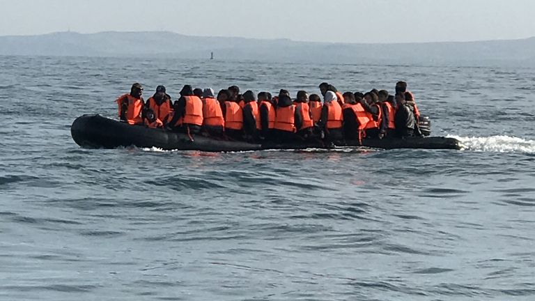 
Re:Migrants  - manhandling a large inflatable boat down a northern French beach, to get to the seafront in order to to cross the Channel.  - re copy from  Adam Parsons and Sophie Garratt
