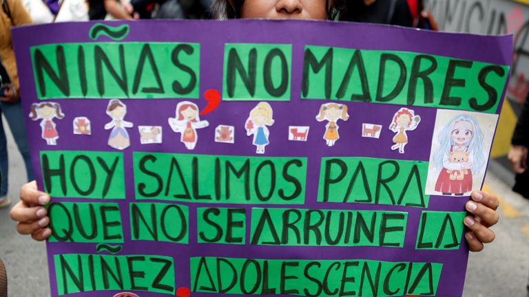 A woman holding up a sign reading "Girls not mothers, today we go out so that childhood, adolescence is not ruined" protests against the interference of the Catholic Church in the judicial decision to interrupt the pregnancy of an 11-year-old girl