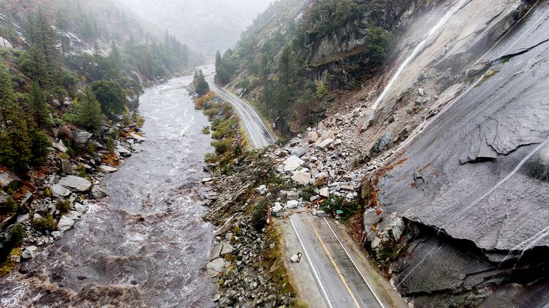 Rocks and vegetation cover Highway 70 following a landslide in the Dixie Fire zone on Sunday, Oct. 24, 2021, in Plumas County, Calif. Heavy rains blanketing Northern California created slide and flood hazards in land scorched during last summer&#39;s wildfires. (AP Photo/Noah Berger)