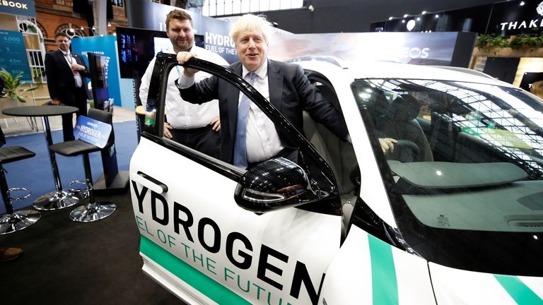 Britain&#39;s Prime Minister Boris Johnson looks on as he visits a trade stall inside the conference venue at the annual Conservative Party conference, in Manchester, Britain, October 5, 2021. REUTERS/Phil Noble
