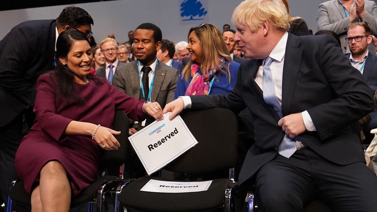 Home Secretary Priti Patel and Prime Minister Boris Johnson speak before Chancellor of the Exchequer Rishi Sunak addresses the Conservative Party Conference in Manchester. Picture date: Monday October 4, 2021.


