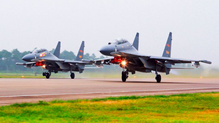Two Chinese SU-30 fighter jets take off from an unspecified location to fly a patrol over the South China Sea. Pic: AP