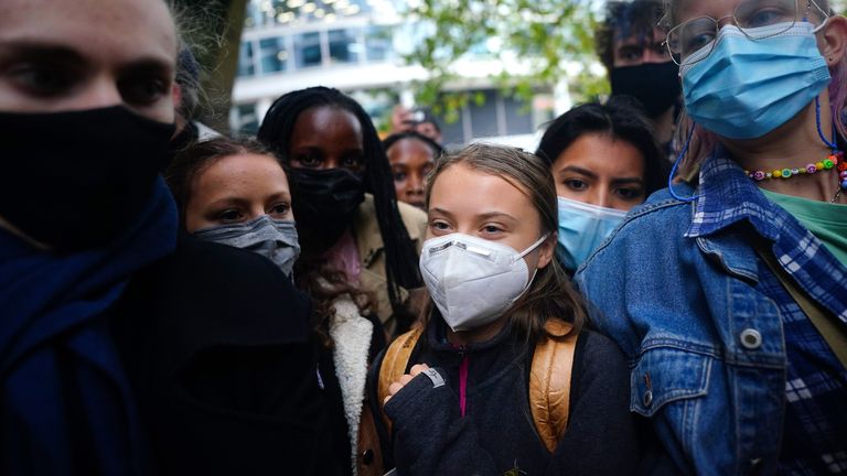 Teenage activist Greta Thunberg (centre) joins activists taking part in the Youth Strike to Defund Climate Chaos protest against the funding of fossil fuels outside Standard Chartered Bank in London. Picture date: Friday October 29, 2021.

