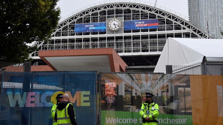 Police officers and security staff patrol outside of the Manchester Central Convention Complex at the annual Conservative party conference in Manchester, Britain, October 2, 2021. REUTERS/Toby Melville
