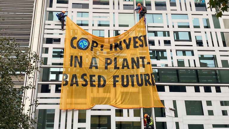 Animal Rebellion protesters have unfurled a banner calling on world leaders to &#39;invest in a plant-based future&#39;. Pic: Matt Grant