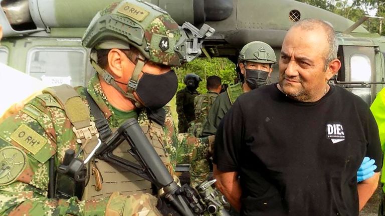 Dairo Antonio Usuga David, alias "Otoniel", top leader of the Gulf clan, is escorted by Colombian military after being captured, in Turbo, Colombia October 23, 2021. Colombian Defense Ministry/Handout via REUTERS ATTENTION EDITORS - THIS IMAGE HAS BEEN SUPPLIED BY A THIRD PARTY. MANDATORY CREDIT. NO RESALES. NO ARCHIVES.