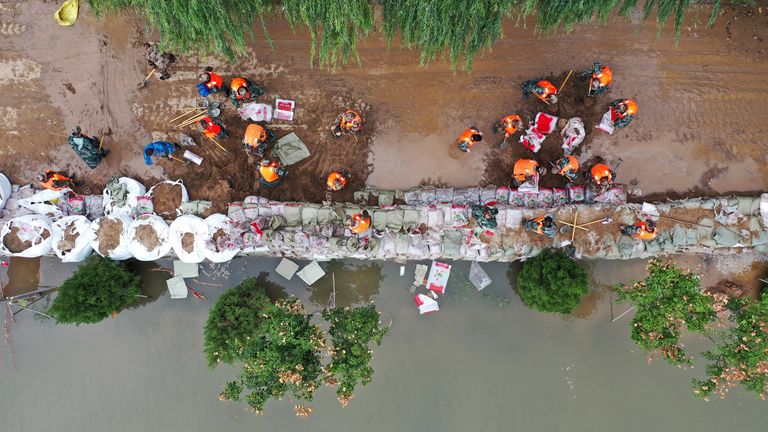 In this photo released by Xinhua News Agency, an aerial photo shows rescuers fortifying temporary dyke against the flood at Lianbo Village in Hejin City in northern China's Shanxi Province on Sunday, Oct. 10, 2021.
PIC:AP