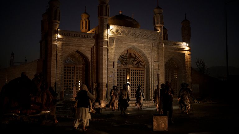 Taliban fighters walk at the entrance of the Eidgah Mosque. Pic: AP