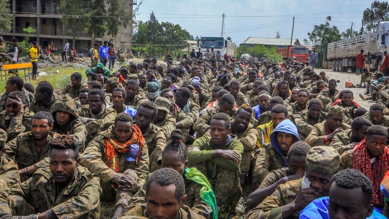 Captured Ethiopian government soldiers and allied militia members sit in rows in Mekelle