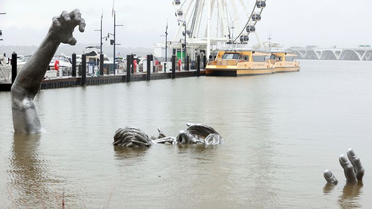 OXON HILL, MD - OCTOBER 29: View of &#39;The Awakening&#39; sculpture at the National Harbor at Oxon Hill, almost completely covered from the Nor&#39;easter currently hitting Maryland on October 29, 2021. Credit: mpi34/MediaPunch /IPX


