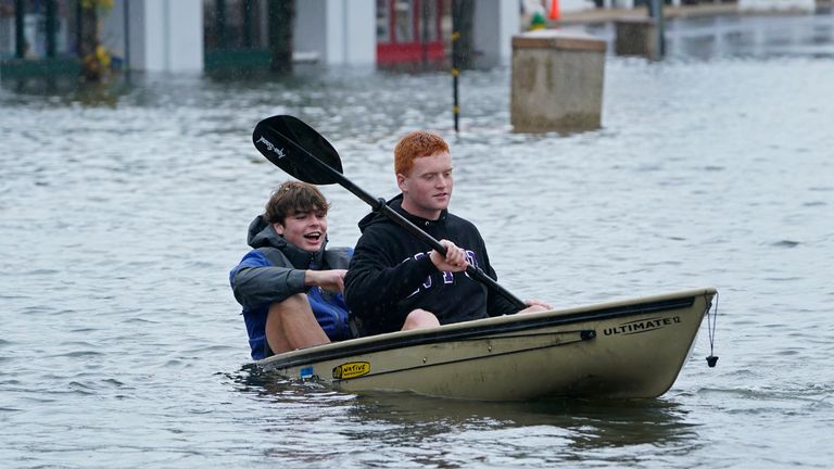People boat through a parking lot as they survey the flooding in downtown Annapolis, Md., Friday, Oct. 29, 2021. The city is anticipating potential historic tidal flooding conditions in low-lying areas Friday and Saturday. (AP Photo/Susan Walsh)      