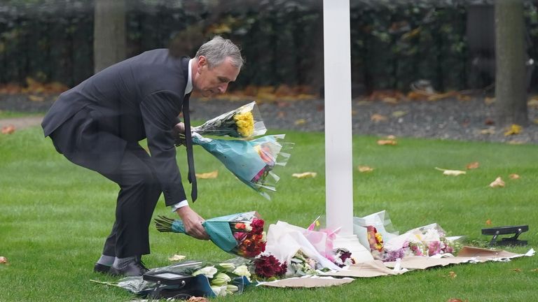Conservative MP Nigel Evans lays flowers inside the gates at the Houses of Parliament in Westminster, London, following the death of Conservative MP Sir David Amess, who died after he was stabbed several times at a constituency surgery at Belfairs Methodist Church in Leigh-on-Sea, Essex, on Friday. Picture date: Monday October 18, 2021.
