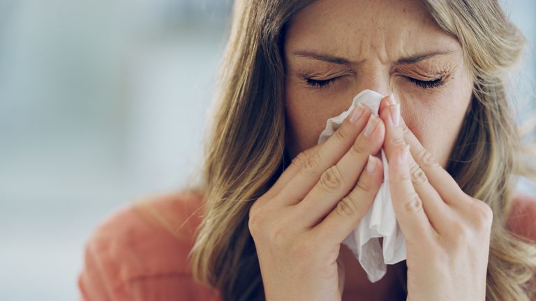 File pic: / stock photo: Shot of an attractive young woman feeling ill and blowing her nose with a tissue at home
.Source: iStock
