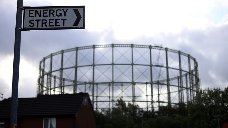 FILE PHOTO: A disused gas holder is seen behind a road sign for Energy Street in Manchester, Britain, September 23, 2021. REUTERS/Phil Noble/File Photo 