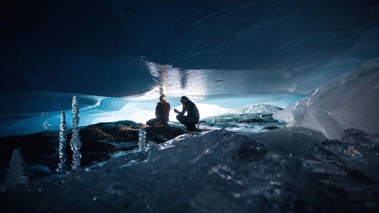 Glaciologists Andrea Fischer and Martin Stocker-Waldhuber, from the Austrian Academy of Sciences, explore a natural glacier cavity of the Jamtalferner glacier near Galtuer, Austria, October 15, 2021. Giant ice caves have appeared in glaciers accelerating the melting process faster than expected as warmer air rushes through the ice mass until it collapses. Picture taken October 15, 2021. REUTERS/Lisi Niesner
