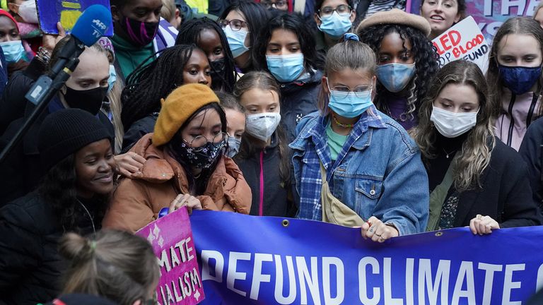 Teenage activist Greta Thunberg (centre left) arrives to join activists taking part in the Youth Strike to Defund Climate Chaos protest against the funding of fossil fuels outside Standard Chartered Bank in London. Picture date: Friday October 29, 2021.
