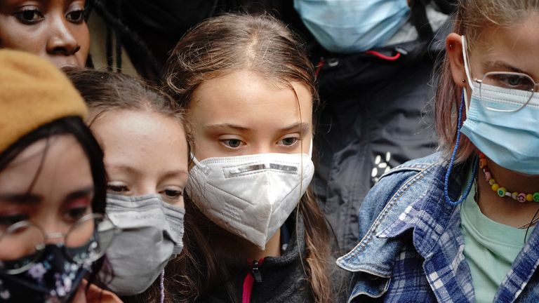 Teenage activist Greta Thunberg (centre left) arrives to join activists taking part in the Youth Strike to Defund Climate Chaos protest against the funding of fossil fuels outside Standard Chartered Bank in London. Picture date: Friday October 29, 2021.

