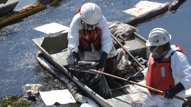 Cleanup contractors deploy skimmers and floating barriers known as booms to try to stop further oil crude incursion into the Wetlands Talbert Marsh in Huntington Beach, Calif., Sunday, Oct. 3, 2021. Pic: AP