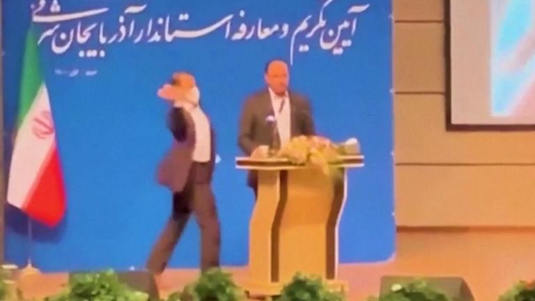 Moment Iranian official is slapped on stage