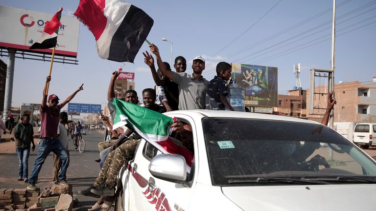 People were pictured chanting and waving flags during the protest in Sudan