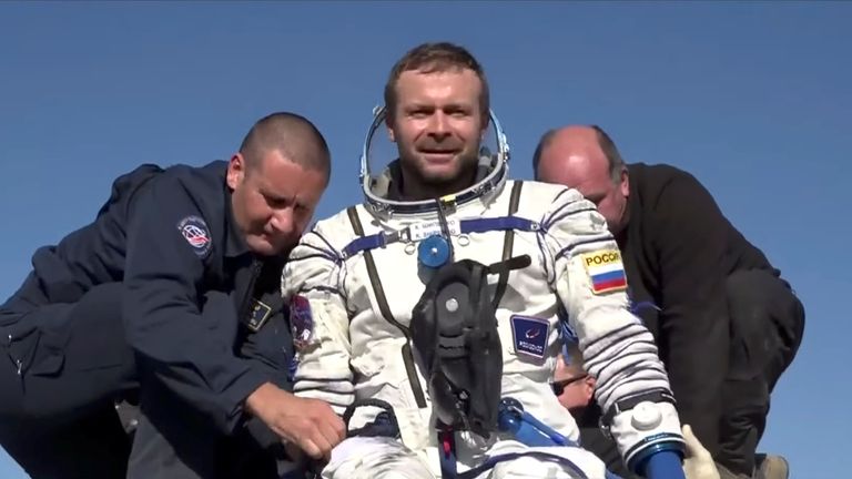 Russian film director Klim Shipenko is assisted by ground personnel shortly after landing. Pic: Roscosmos via Reuters