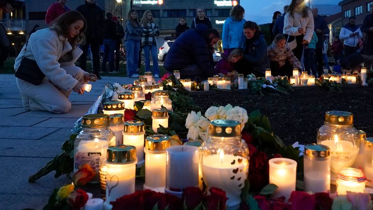 Members of the town lay candles and flowers at the scene of the attack. Pic: AP