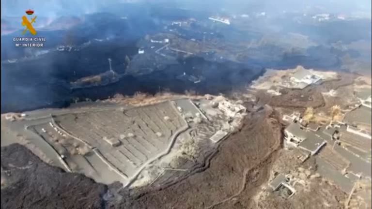 Drone footage shows black lava flowing from La Palma towards the ocean