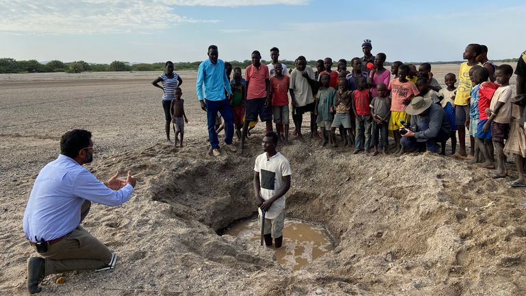 Ashish Joshi talking to Epae Karika in his water hole on there Nakiria river bed, Lake Turkana