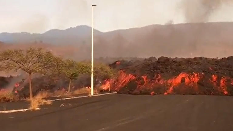 Lava from the Cumbre Vieja volcano on the Canary Island of La Palma engulfed a road at an industrial park.